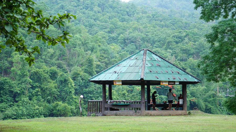 Built structure on landscape against trees