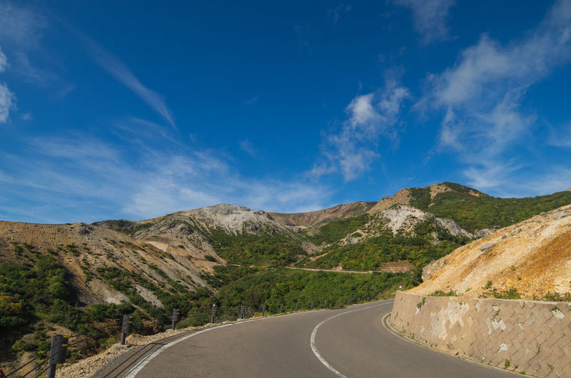 Empty road along rocky landscape