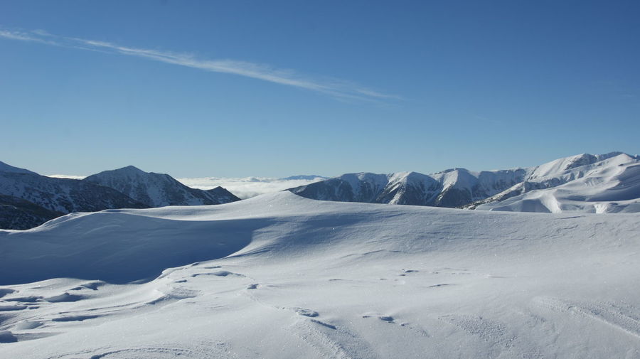 Scenic view of snowcapped mountains against sky