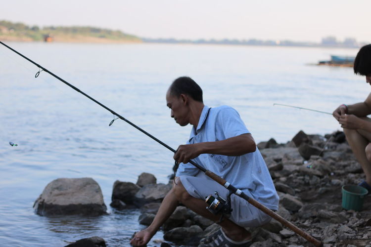 People fishing in lake