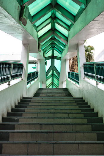 Empty bts sky train station stairway with green top in bangkok
