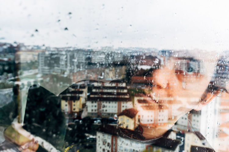 Depressed man looking through window
