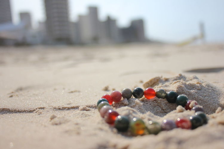 Bracelet on sand during sunny day