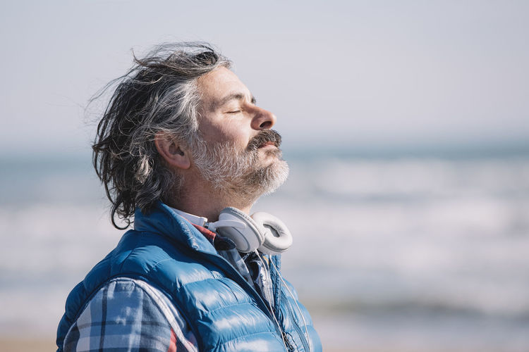 A man on the beach. relaxing deep breathing. person