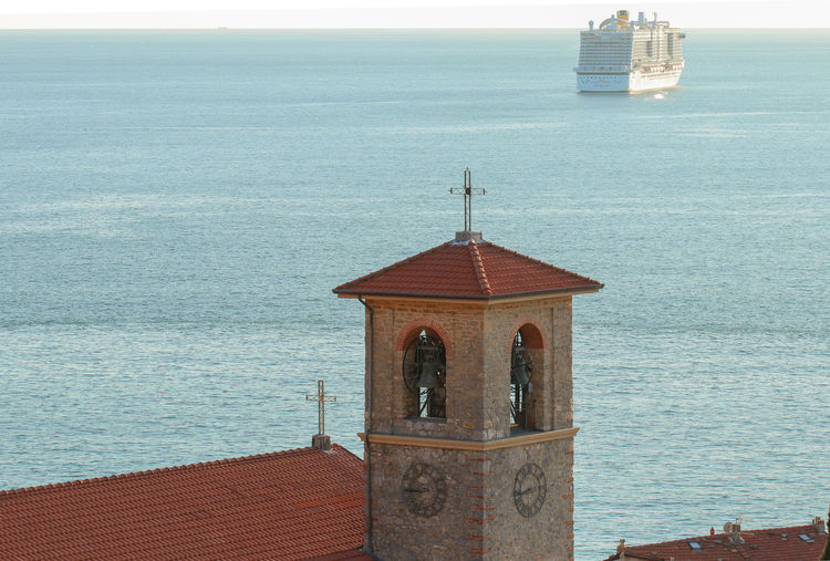 Built structure by sea against sky