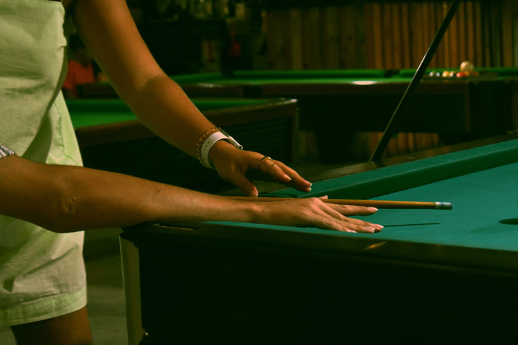 Friends touching while while playing billiards