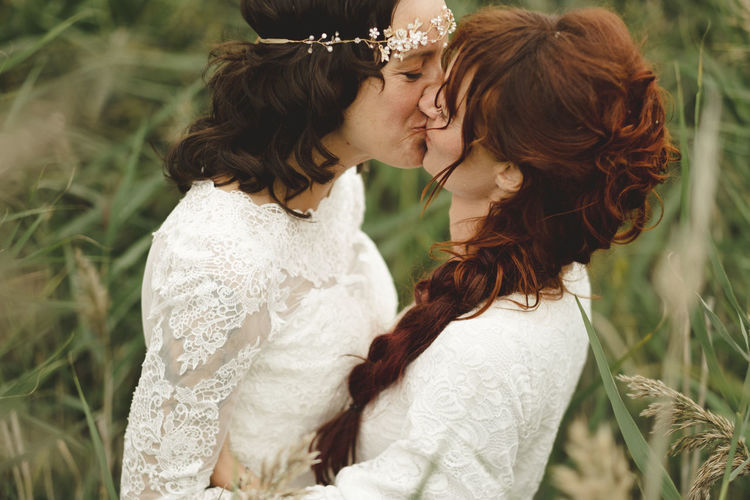 Brides kissing