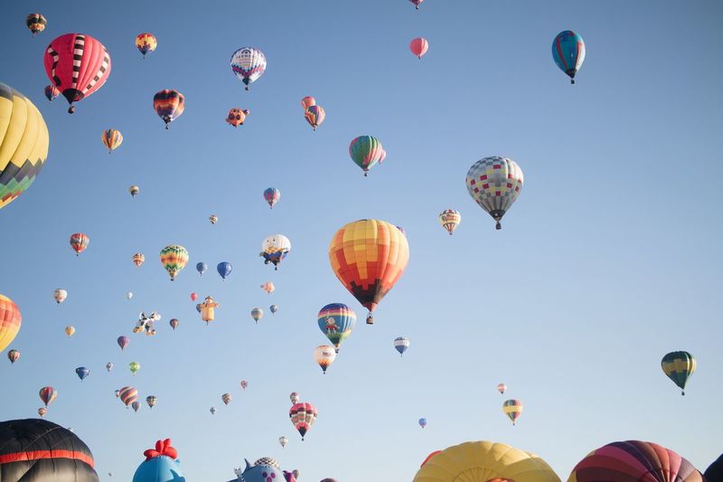 Low angle view of hot air balloons in clear sky