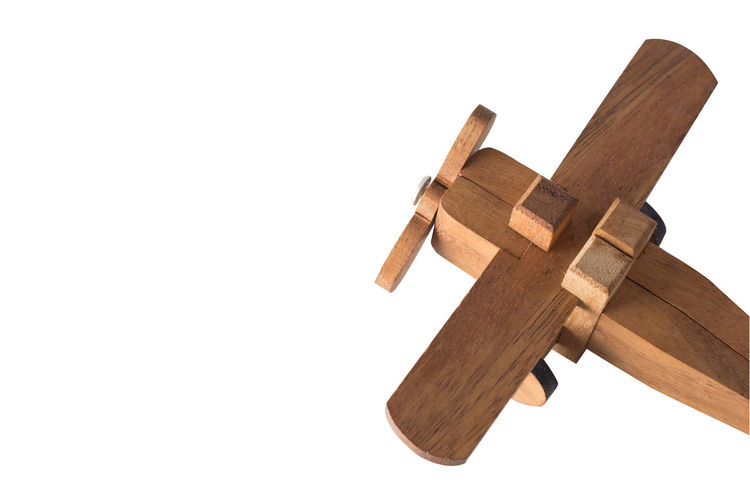 Low angle view of cross on wood against white background