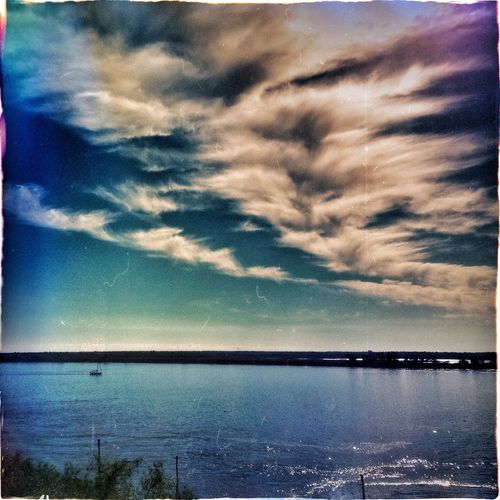 Scenic view of sea against cloudy sky