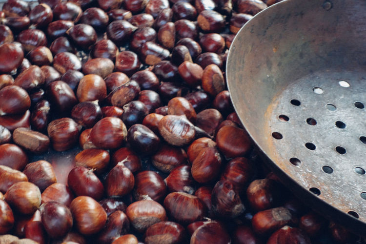 Close-up of chestnuts and colander