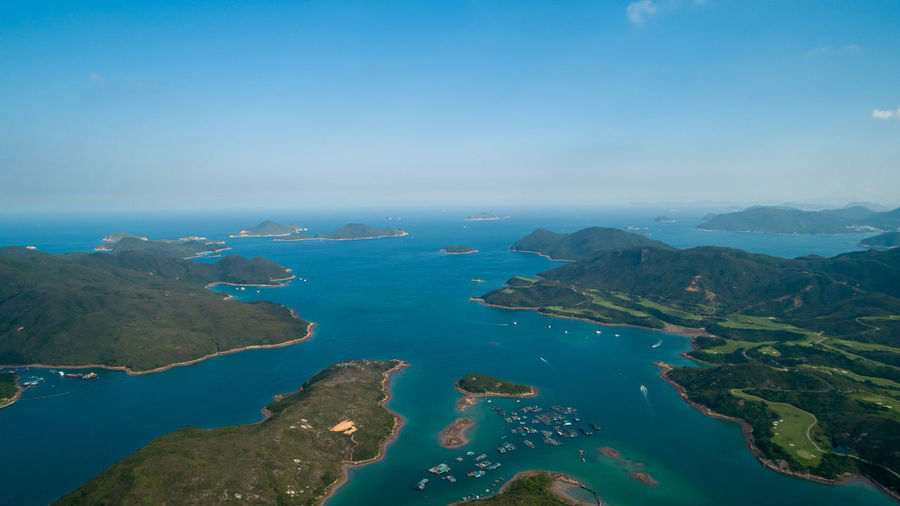 Scenic view of sea and mountains against sky