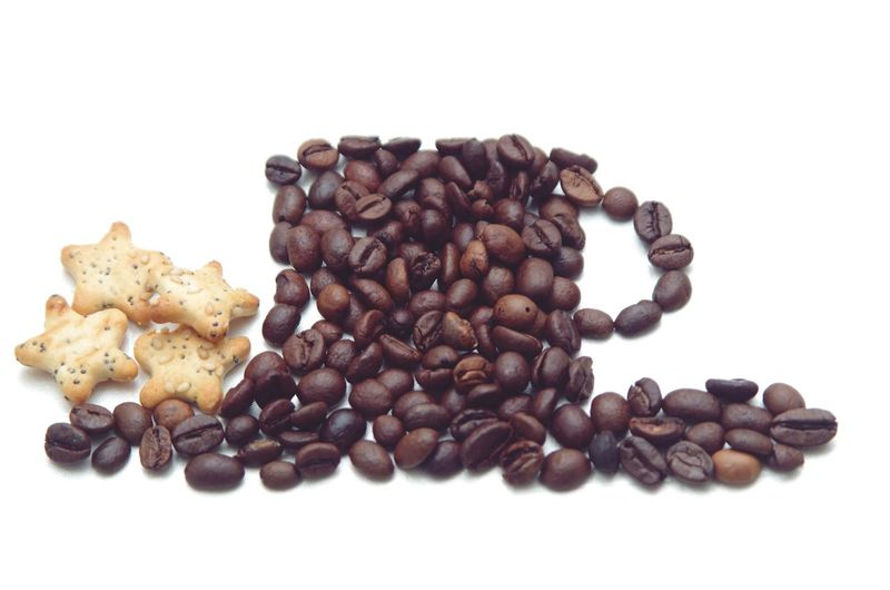 Close-up of coffee beans against white background