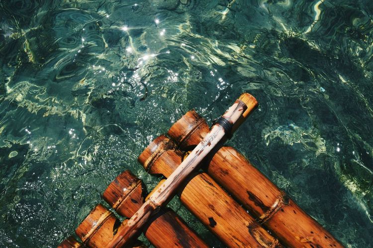 Extreme close-up of wooden raft in water