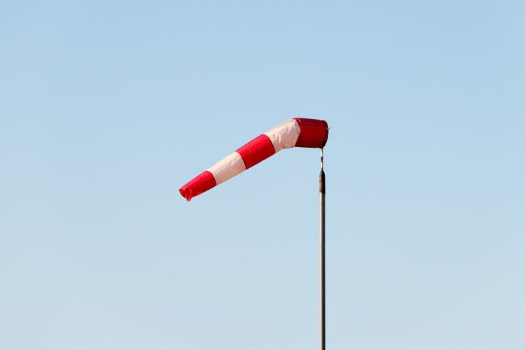 Low angle view of red pole against clear sky