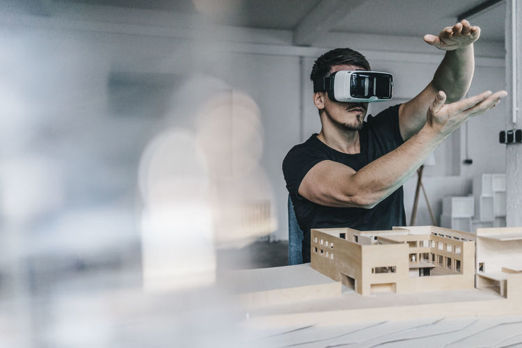 Man with architectural model and vr glasses