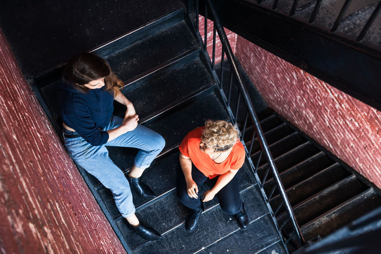High angle view of people sitting on staircase