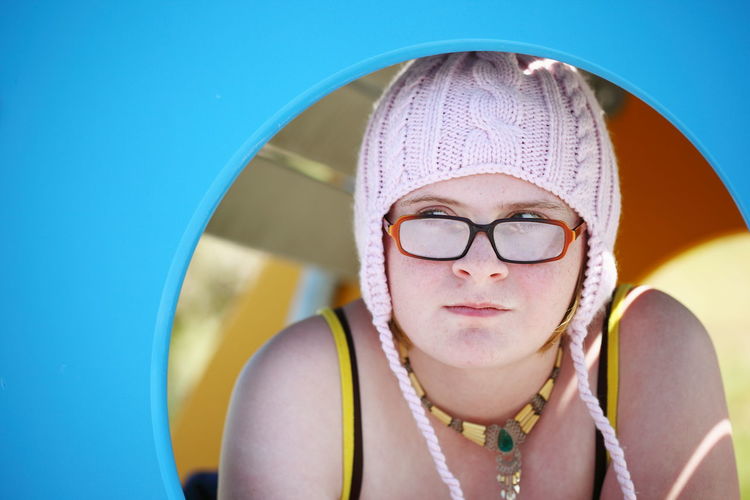 Young woman in knit hat seen through circle