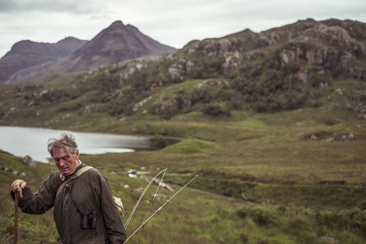 Retired man climbs mountain over loch on fishing trip in scotland