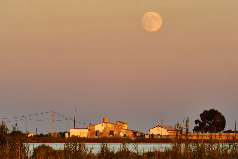 Scenic view of moon against sky at sunset