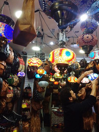 Illuminated lanterns hanging in store