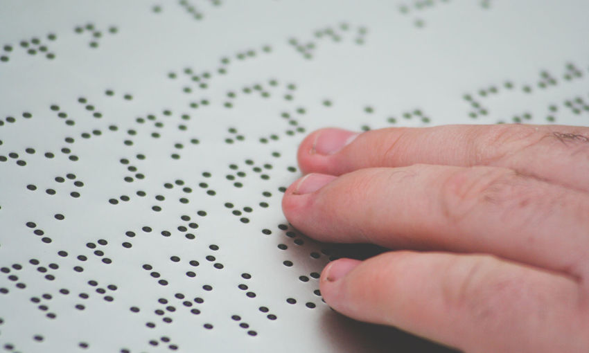 Close-up of finger reading braille