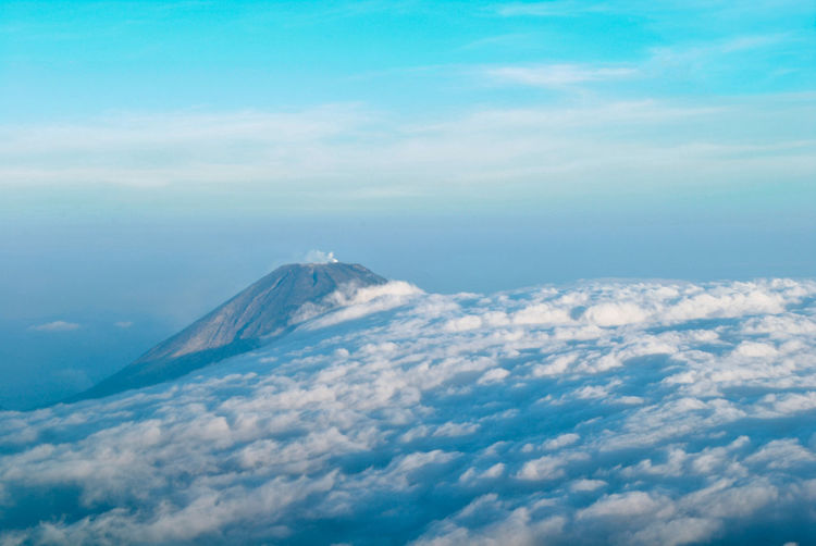 Aerial view of volcanic mountain against sky