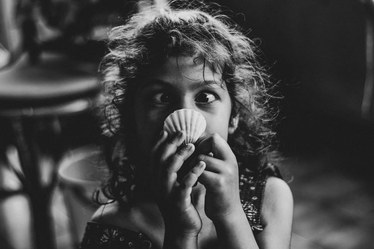 Portrait of girl holding seashell