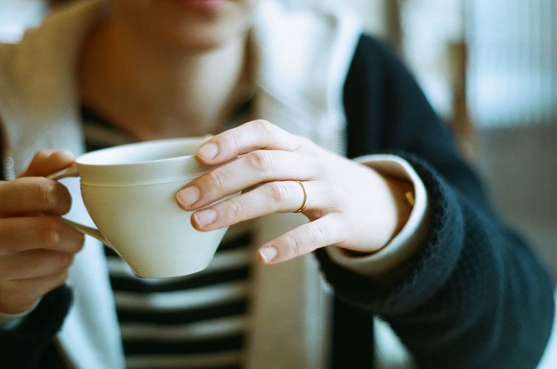 Mid section of woman holding tea cup