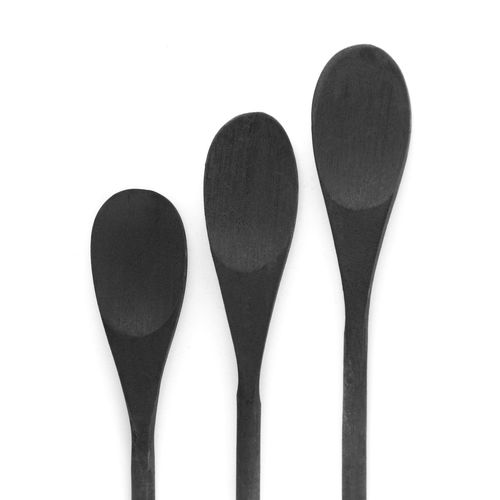 Directly above shot of black spoons on white background