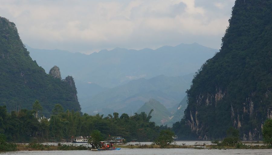Panoramic view of bay and mountains against sky