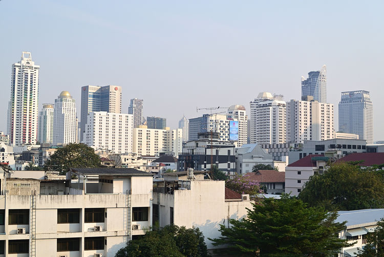 Buildings in city against clear sky