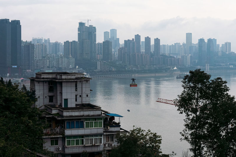 Aerial view of lake by buildings in city