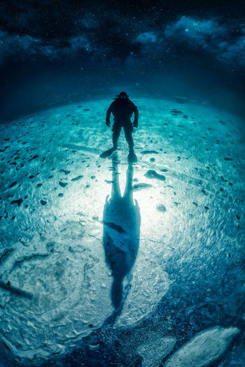 Full length of silhouette man swimming in sea