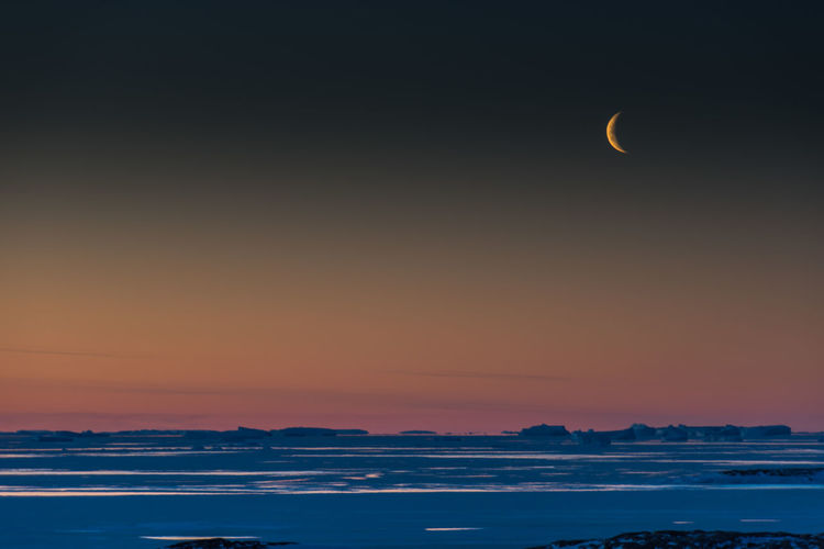 Scenic view of sea against sky at night