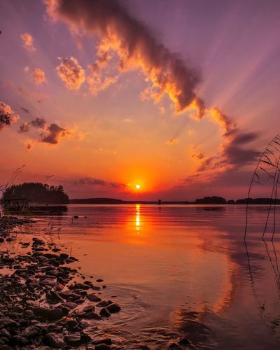 Scenic view of sea against romantic sky at sunset