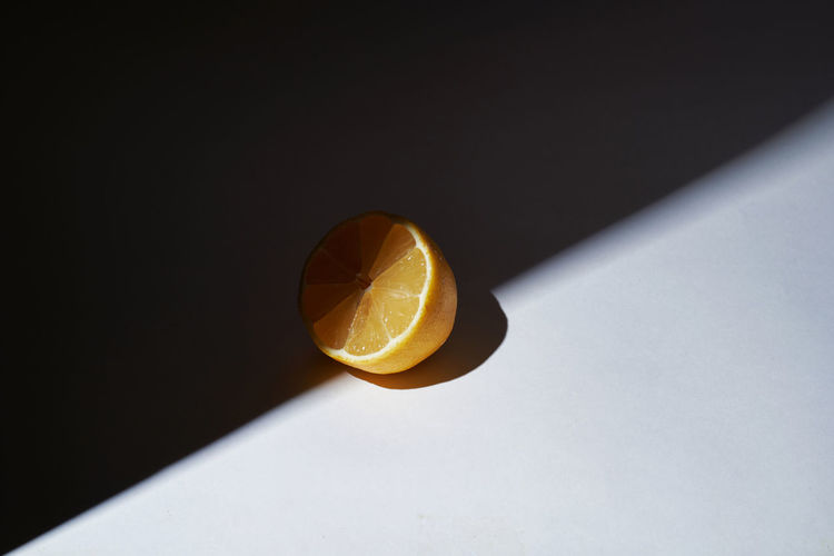 High angle view of orange slice on white background
