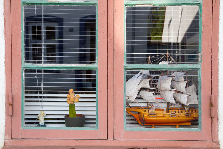 Miniature model of sailing ship seen through window of store