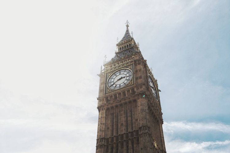 Low angle view of clock tower against sky