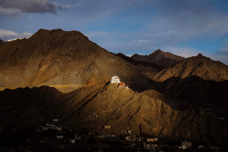 Scenic view of mountain and sunset light shining on leh palace 