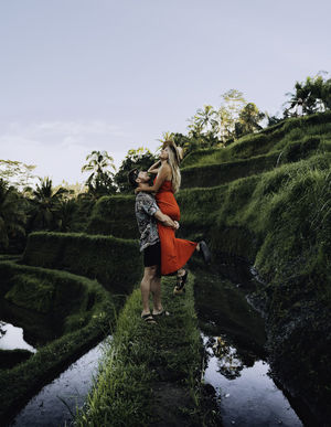 Rear view of woman on land against sky