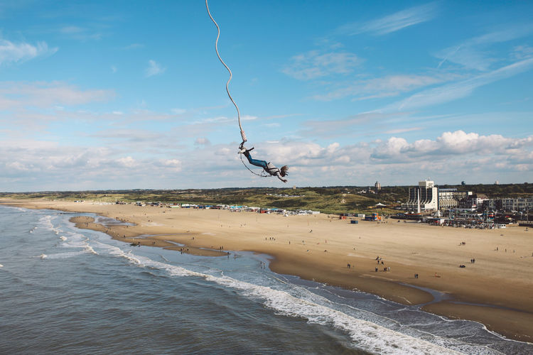Woman bungee jumping at beach