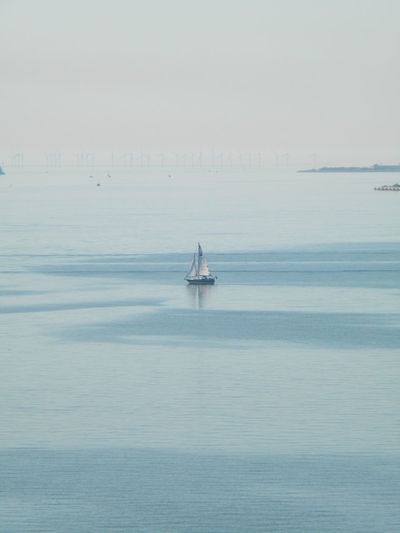 Sailboat in sea against sky