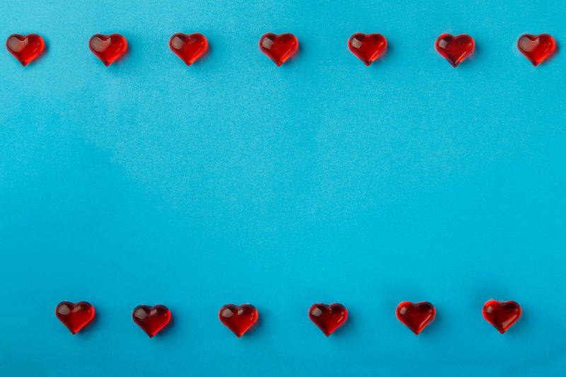 Directly above shot of red heart shapes on blue background