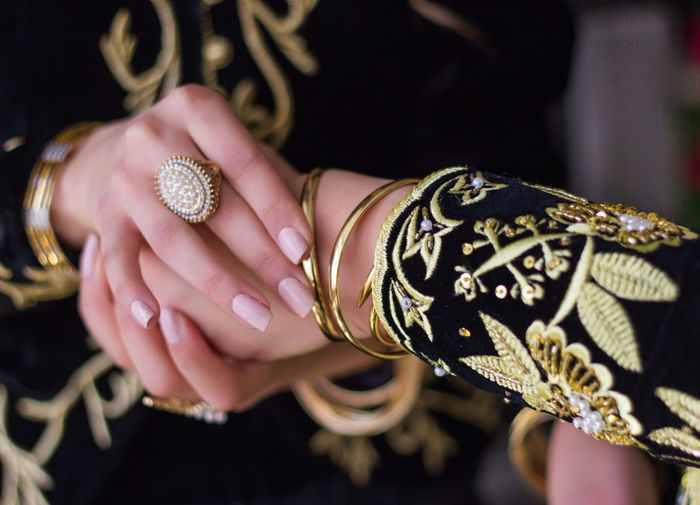 Cropped image of bride holding friend hand during wedding