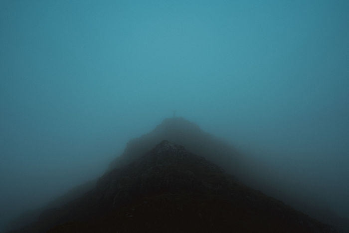 Silhouette mountain against sky during foggy weather