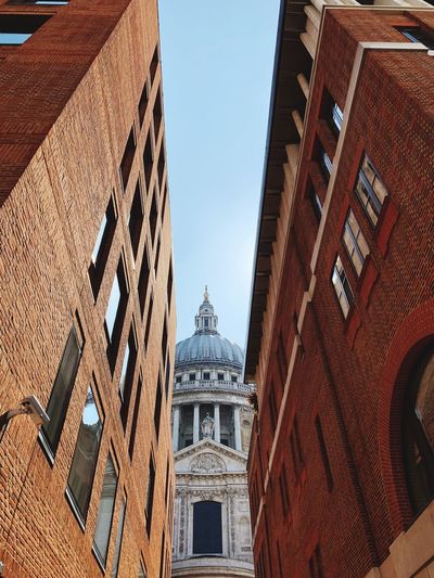 Low angle view of st paul cathedral and buildings against sky 