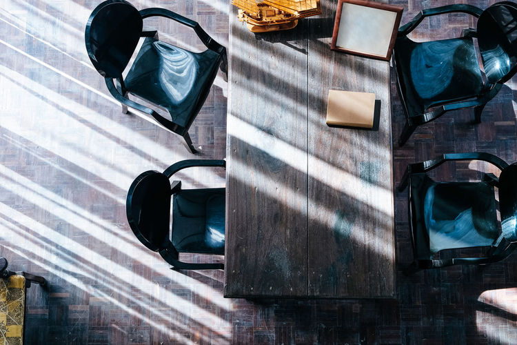High angle view of empty picture frame with box and model ship over table at restaurant