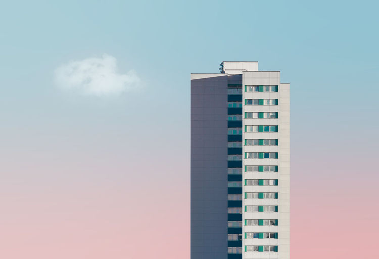 Skyscraper against sky during sunset