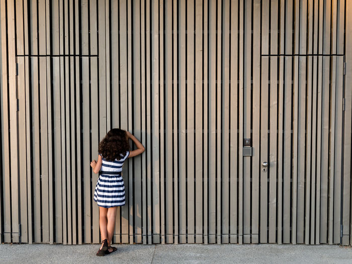 Curiosity Saint Julien En Genevois Curiosity Streetphotography Street Photo De Rue Fille Stripes Bois Wood - Material Kids Enfant Girl Childhood Child Full Length Standing Pattern Closed Locked Closed Door Door Gate Keyhole Door Knocker Doorknob Lock Entryway Door Handle Entry EyeEmNewHere